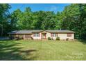 Inviting single-story home featuring a well-manicured lawn and charming red shutters, offering classic curb appeal at 2310 Alexis Lucia Rd, Stanley, NC 28164