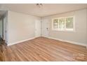 Spacious living room with wood floors, neutral walls, and bright light at 2409 Thornton Rd, Charlotte, NC 28208