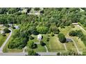 Aerial view of the neighborhood with lush trees and the home at the center of the wooded lot at 2645 Kool Park Ne Rd, Hickory, NC 28601