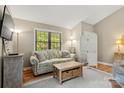 Cozy living room featuring a comfortable sofa, wooden floors, and a bright window with a view at 2750 Victory Ct, Fort Mill, SC 29715