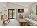 Bright living room with sliding glass doors to deck, showcasing a comfortable rocking chair and stylish decor at 2750 Victory Ct, Fort Mill, SC 29715