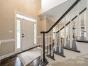 Bright foyer with hardwood floors, stairs, and natural light at 2907 Notchview Ct, Charlotte, NC 28210