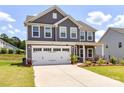 Two-story home showcasing a two car garage, manicured lawn, and professional landscaping at 3023 Ballester Rd, Fort Mill, SC 29707