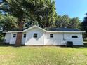 Exterior of home's backyard with vinyl siding and well maintained green grass at 345 Mountain View St, Gastonia, NC 28052