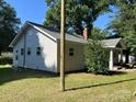 Home's exterior features vinyl siding, a brick chimney and a well maintained lawn at 345 Mountain View St, Gastonia, NC 28052