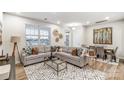 Spacious living room featuring a cozy sectional, modern decor, and ample natural light at 3844 Cheyney Park Dr, Charlotte, NC 28269