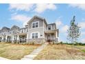 Charming two-story townhouse with stone accents, a covered front porch, and landscaped yard at 3936 Cheyney Park Dr, Charlotte, NC 28269