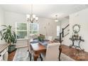 Bright dining room featuring hardwood floors, a classic chandelier, and plenty of natural light at 40154 Crooked Stick Dr, Lancaster, SC 29720