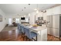 This open concept kitchen boasts granite countertops, stainless appliances, and a breakfast bar with seating at 40154 Crooked Stick Dr, Lancaster, SC 29720