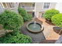 Overhead courtyard view of a serene fountain surrounded by lush greenery and brick paving at 5011 Sharon Rd # Q, Charlotte, NC 28210