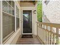 Inviting entryway with a 'Hello' mat, glass storm door and natural light streaming through a window at 5011 Sharon Rd # Q, Charlotte, NC 28210