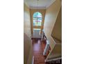 View from above the foyer shows tall ceilings, grand window, and hardwood floors at 6017 Lowergate Dr, Waxhaw, NC 28173