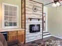 Living area with electric fireplace feature wall, natural light, and open layout at 625 Wildwood Dr, Rock Hill, SC 29730