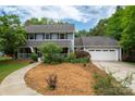 Attractive two-story home boasts well-maintained landscaping and an attached two-car garage at 6512 Porterfield Rd, Charlotte, NC 28226