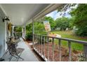 Inviting front porch view with decorative railings and view of front yard landscaping at 6512 Porterfield Rd, Charlotte, NC 28226