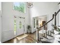 Bright foyer with hardwood floors, staircase, and a large window above the front door at 706 Evans Manor Dr, Weddington, NC 28104