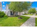 Charming two-story home with a well-manicured lawn and inviting front porch featuring an outdoor bench at 7316 Hamilton Bridge Rd, Charlotte, NC 28278