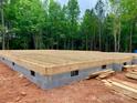 Image shows a new home foundation with gray cinder blocks and wooden construction with a wooded area in the background at 762 Highway 274 Rd, Clover, SC 29710