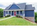 Charming blue two-story home with a red front door and white railings leading to a well-manicured lawn at 7768 Pinecone Ln, Hickory, NC 28602