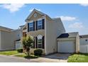 Attractive two-story home with a garage and well-kept lawn on a sunny day at 8610 Sawleaf Ct, Charlotte, NC 28215