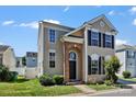 Inviting two-story home with brick archway, black shutters, and lush green lawn at 8610 Sawleaf Ct, Charlotte, NC 28215