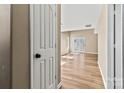 Sunlit living room with gleaming hardwood floors and neutral paint at 8610 Sawleaf Ct, Charlotte, NC 28215