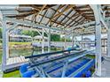 Covered boat dock featuring boat lift and picturesque views of the lake and surrounding waterfront homes at 9561 Island Point Rd, Sherrills Ford, NC 28673