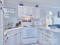 Cozy kitchen featuring white appliances and unique design elements at 108 Britt Ln, New London, NC 28127