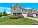 Attractive two-story home with stone facade, a two-car garage, and a well-manicured lawn at 12217 Dearview Ln, Charlotte, NC 28269