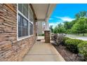 Inviting front porch with stone pillars and siding, offering a glimpse of the neighborhood street at 12217 Dearview Ln, Charlotte, NC 28269