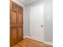 Inviting entryway with gleaming hardwood floors and stylish paneled doors, creating a warm and welcoming ambiance at 1227 Seneca Pl, Charlotte, NC 28210