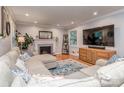 Bright living room features hardwood floors, recessed lighting, a cozy fireplace, and ample seating space at 1227 Seneca Pl, Charlotte, NC 28210