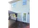 Covered deck with outdoor lighting and 'hello' doormat at door entrance at 12304 Sandringham Pl, Charlotte, NC 28262