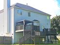 Back of house featuring large deck with gazebo, stairs to backyard, and vinyl siding at 12304 Sandringham Pl, Charlotte, NC 28262