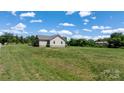 Spacious backyard with lush green grass surrounding the home, creating a serene outdoor space at 125 Carter Ln, Statesville, NC 28625