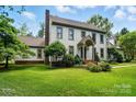 Classic two-story home with brick chimney and landscaped yard at 1295 Patterson St, China Grove, NC 28023