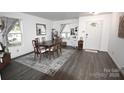 Bright dining room with modern flooring, a large window, and stylish décor at 1332 Waterlily Ln, Charlotte, NC 28262