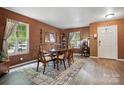Warm dining room with a rustic rug, natural light, and inviting decor at 1332 Waterlily Ln, Charlotte, NC 28262
