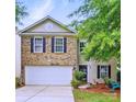 Charming two-story home featuring a brick facade, a two-car garage and a well maintained front yard at 1332 Waterlily Ln, Charlotte, NC 28262
