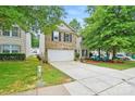 Charming two-story home with a well-maintained lawn, inviting front porch area, and two car garage at 1332 Waterlily Ln, Charlotte, NC 28262