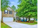 Charming two-story home featuring a brick facade, a two-car garage and a well maintained front yard at 1332 Waterlily Ln, Charlotte, NC 28262