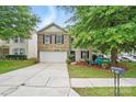 Charming two-story home with a well-maintained lawn, inviting front porch area, and two car garage at 1332 Waterlily Ln, Charlotte, NC 28262