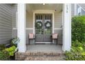 Inviting front porch featuring double doors, stylish seating, and a charming neighborhood vibe at 136 Preston Rd, Mooresville, NC 28117