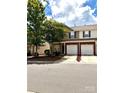 Charming townhome features an attached one-car garage and classic brick accents at 13612 Singleleaf Ln, Charlotte, NC 28278