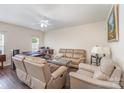 Comfortable living room featuring new floors and a ceiling fan for added comfort at 13612 Singleleaf Ln, Charlotte, NC 28278