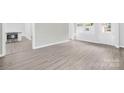 Bright living room with laminate floors, freshly painted grey brick wall and new windows at 1408 Delview Rd, Cherryville, NC 28021