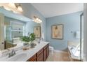 Bright, dual vanity bathroom with a bathtub and separate shower; provides a serene and functional space at 14512 Brotherly Ln, Charlotte, NC 28278