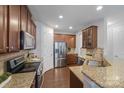 Well-equipped kitchen features stainless steel appliances, granite countertops and wood cabinets at 14512 Brotherly Ln, Charlotte, NC 28278