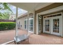 Covered patio with wood flooring and an exterior view, perfect for outdoor relaxation and entertaining at 14822 Rocky Top Dr, Huntersville, NC 28078