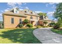 Two-story brick home with well-maintained lawn and landscaping, showcasing a welcoming entrance at 150 Northchase Dr, Concord, NC 28027